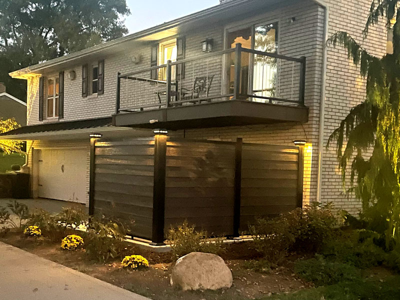 Elevated balcony and deck addition with privacy screen by Stellar Construction