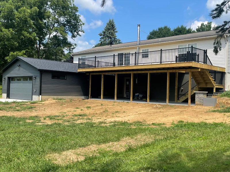 Rear elevation with new raised deck and attached garage by Stellar Construction